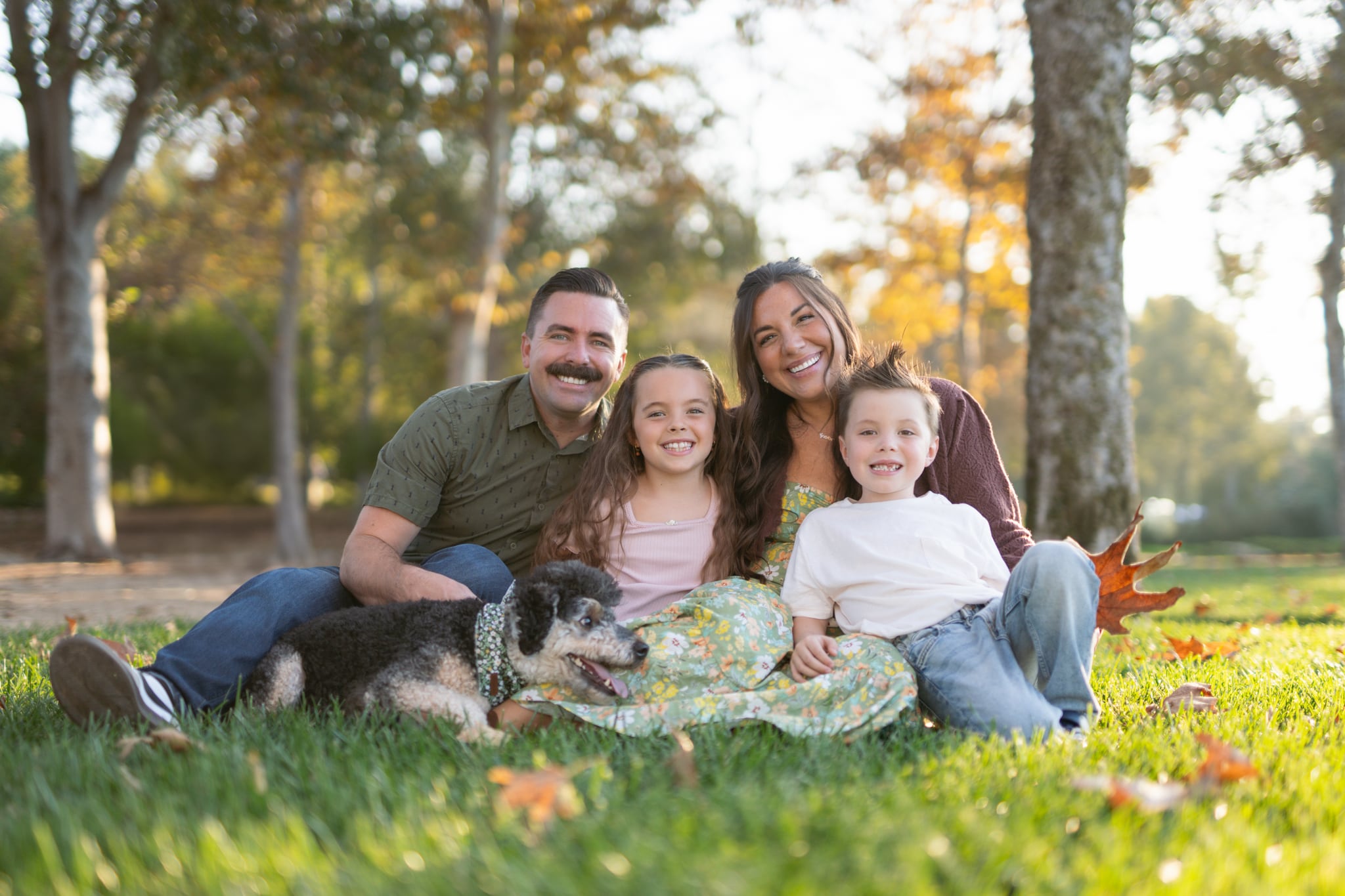 Family sitting in the grass at Jeffrey Open Space Trail
